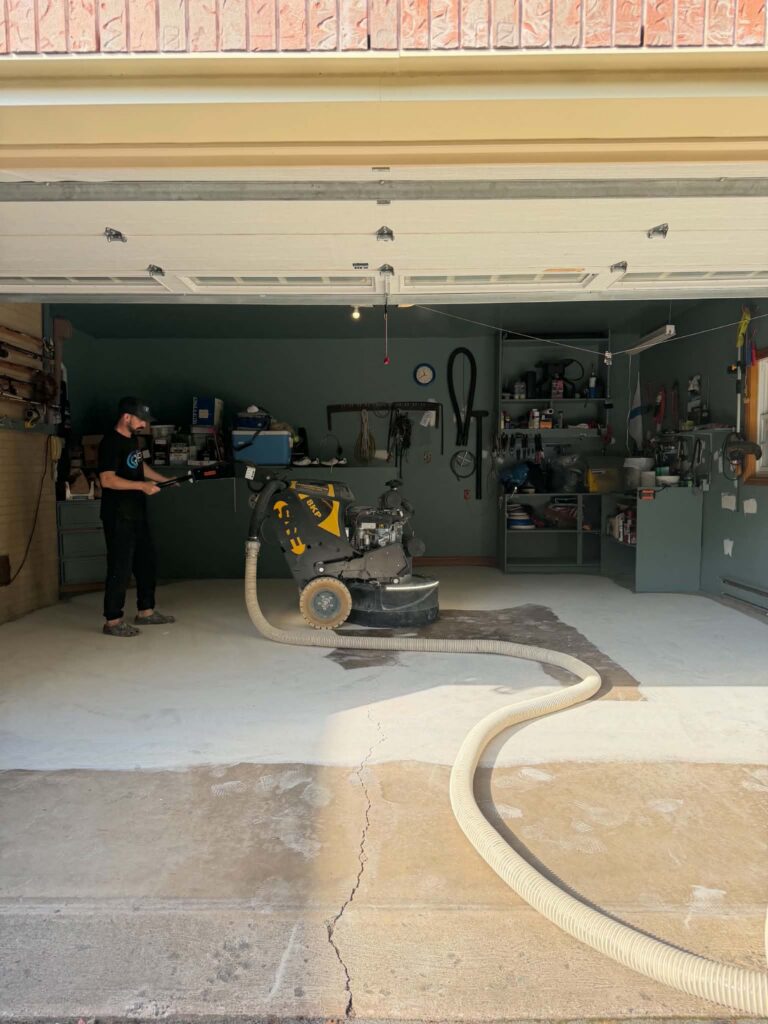 Diamond grinding a Sackville NS garage floor before coating, with dust extraction